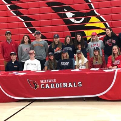 Eva Andersen with others is posing wearing their University Shirts.
